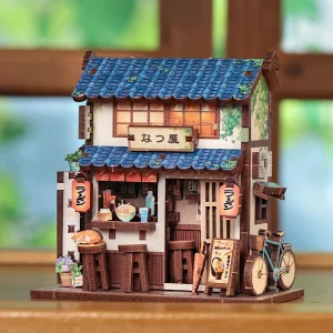 Magnet miniature Ramen Shop en bois représentant un restaurant japonais traditionnel avec toit bleu, lanternes rouges et petits accessoires détaillés.